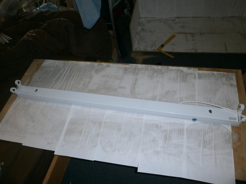 Attaching the lights. The white stuff is printer paper, intended to reflect more of the light than just the wood.