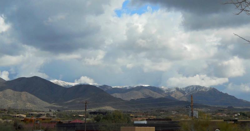 Snow on the mountains north of the new location.